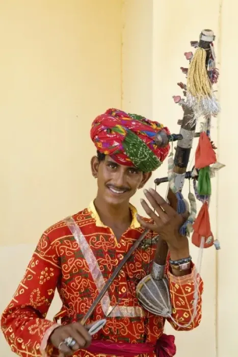 Framed Print : Young man in traditional costume playing old fashioned guitar instrument called a Framed Print : Young man in traditional costume playing old fashioned guitar instrument called a