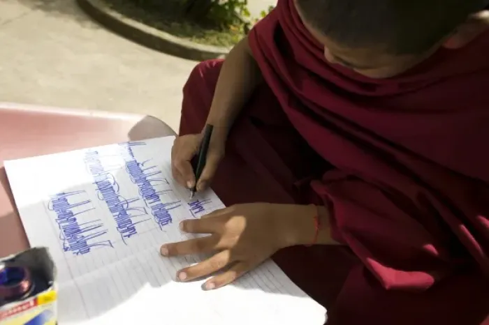 Framed Print : Young monk practicing calligraphy, Dharamsala, India