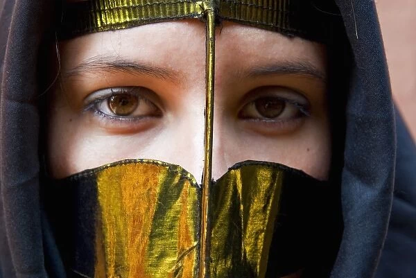 A young woman in traditional arab mask (bathoula) and dress, Dubai, United Arab Emirates