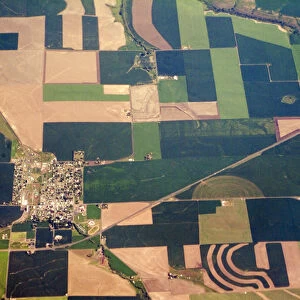 Aerial view of small town surrounded by patchwork quilt of agricultural fields in Willamette Valley