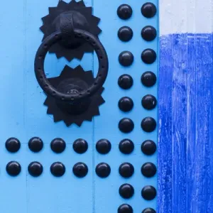 Africa, Morocco, Chefchaouen. Detail of blue door and doorknocker