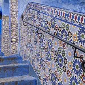 Africa, Morocco, Chefchaouen. Decorated tile wall of stairway