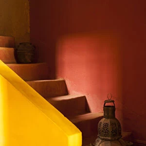 Africa, Morocco. An old lantern and jug on steps of a restored Kasbah with a texture