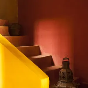 Africa, Morocco. An old lantern and jug on steps of a restored Kasbah with a texture
