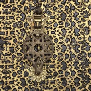 Africa, Morocco. A detail of an ornate brass door and fancy door knocker