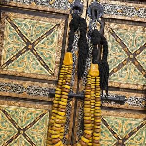 Africa, Morocco, Tinerhir. Traditional necklace of Berber woman hangs on an ornate