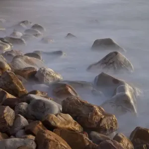 Africa, South Africa, Cape Town. Rocks and waves on Llandudno Beach at sunset. South Africa Africa, South Africa, Cape Town. Rocks and waves on Llandudno Beach at sunset. South Africa