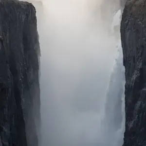 Africa, Zimbabwe, Victoria Falls. Waterfall and spray at sunrise Africa, Zimbabwe, Victoria Falls. Waterfall and spray at sunrise