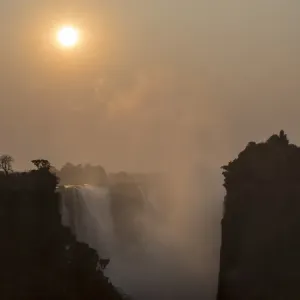 Africa, Zimbabwe, Victoria Falls. View of waterfall at sunrise Africa, Zimbabwe, Victoria Falls. View of waterfall at sunrise