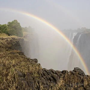 Africa, Zimbabwe, Victoria Falls. Rainbow over waterfall