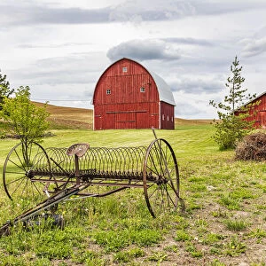 Albion, Washington State, USA. Red barns and antique farm equipment in the Palouse hills