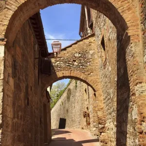 Ancient Stone Arches Street Flowers Medieval Town San Gimignano Tuscany Italy