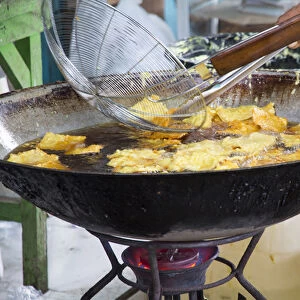 Asia, Indonesia, Bali. Frying Indonesian food called bali bakwan and tofu goreng