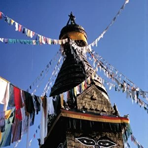 Asia, Nepal, Kathmandu Valley. Dawn lights the face of Swayambunath and the prayer