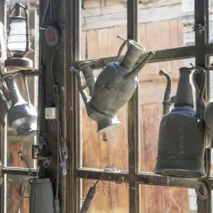 Azerbaijan, Lahic. Antique kettles hanging on the inside of a window
