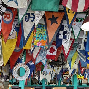 Bahamas, Exuma Island. Flags on ceiling of bar at Yacht Club