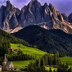 Beautiful isolated lonely church St Maddalena and village in valley in the Italian