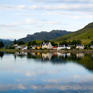 Beautiful photo of small village of Dornie with refections and boat in Western Highlands