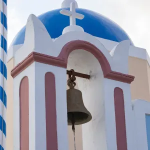 Blue domed Greek Orthodox church with bell in Oia, Santorini, Greece