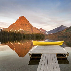 Boats on calm morning at Two Medicine Lake in Glacier National Park, Montana, USA