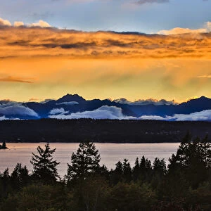 Bremerton, Washington. The Olympic Mountains, featuring Brothers Mountain, bask in a golden