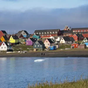 Brightly painted houses on the beach, Qeqertarsuaq, Greenland Brightly painted houses on the beach, Qeqertarsuaq, Greenland