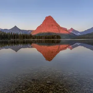 Calm reflection in Two Medicine Lake in Glacier National Park, Montana, USA