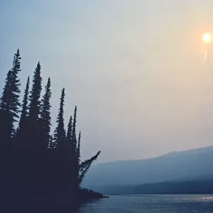 Canada, Northwest Territories, Nahanni National Park. Fire smoke on Nahanni River