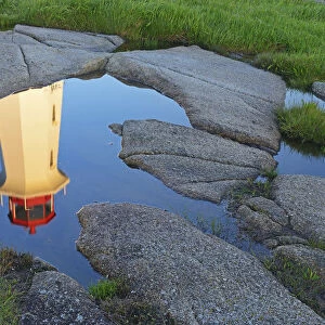 Canada, Nova Scotia. Peggys Cove Lighthouse reflection in water