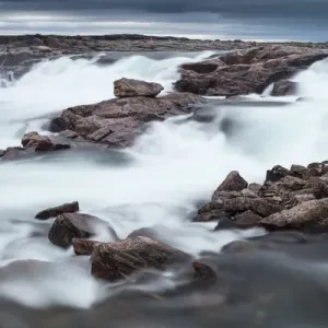 Canada, Nunavut Territory, Blurred image of rushing waterfall near Bury Cove along Canada, Nunavut Territory, Blurred image of rushing waterfall near Bury Cove along