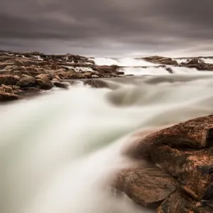 Canada, Nunavut Territory, Blurred image of rushing waterfall near Bury Cove along Canada, Nunavut Territory, Blurred image of rushing waterfall near Bury Cove along