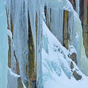 Canada, Ontario, Baysville. Ice from frozen waterfall on side of rock face. Credit as