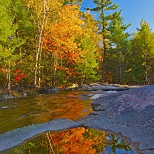Canada, Ontario. Fall reflections on Rosseau River at Lower Rosseau Falls. Credit as
