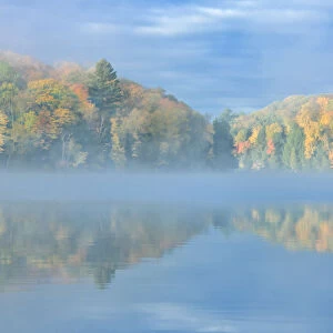 Canada, Ontario, Horseshoe Lake. Cottage in morning fog on lake