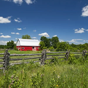 Canada, Ontario, Limoges. Red barn and wooden fence. Credit as