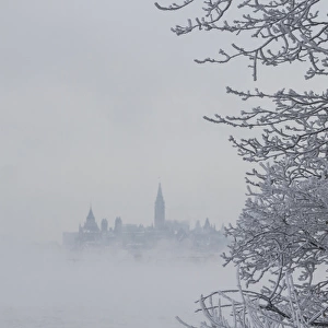 Canada, Ottawa, Ottawa River. Parliament buildings seen through fog