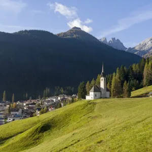 The church, in the background Focobon mountain range in the Pale di San Martino