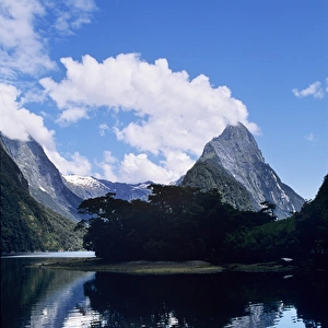 Cloud-capped Mitre Peak rises out of Milford Sound in Fiordland National Park, South Island