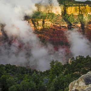 Clouds roll through the incredible rock formations of Bright Angel Point at the rugged