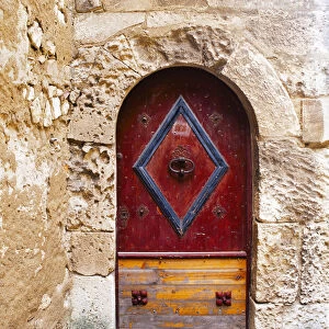 Colorful door in the stone wall of a chateau in France