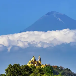 Colorful yellow Iglesia de Nuestra Senora de los Remedios, Popocatepetl, Cholula, Puebla