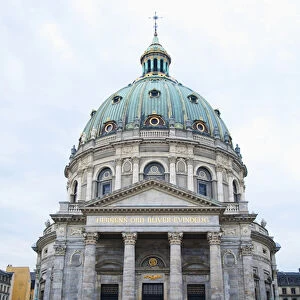 Copenhagen, Denmark - The front of a historic building with columns and a dome. In