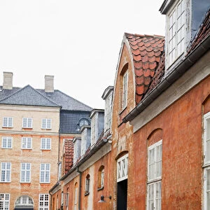 Copenhagen, Denmark - An image of an old world, cobblestone street and surrounding buildings