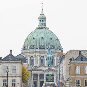 Copenhagen, Denmark - An ornate, domed building with a statue in the foreground