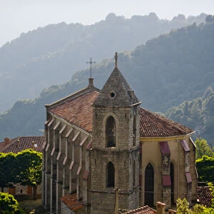 Corsica. France. Europe. Church & house in mountain village of Zicavo above gorge of Molina River