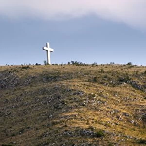A cross on a hilltop near the city. Historic town of Mostar. Federation Bosne i Hercegovine