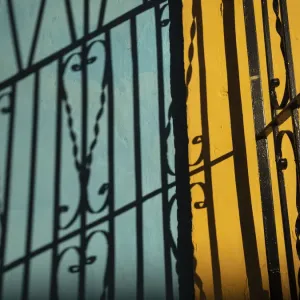 Cuba, Camaguey, UNESCO World Heritage Site, wrought iron gate and colorful walls