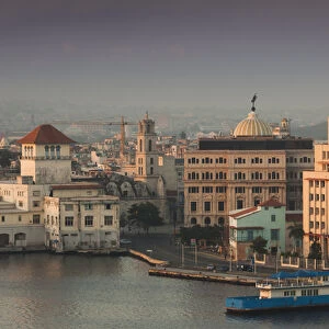 Cuba, Havana, Havana Vieja, elevated view of buildings along Havana Bay, dawn