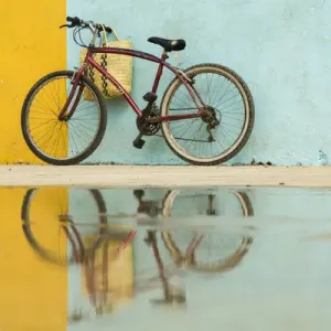 Cuba, Trinidad. Bicycle and reflection against yellow and blue walls Cuba, Trinidad. Bicycle and reflection against yellow and blue walls