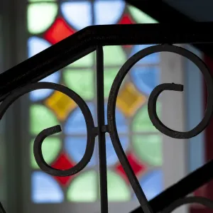 Cuba, Vinales, wrought iron railing and stained glass window Cuba, Vinales, wrought iron railing and stained glass window